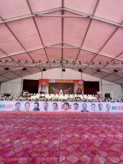 The stage setup for a major political event. We construct large, elevated platforms complete with professional lighting trusses, sound systems, and branding banners to meet the specific needs of public functions.