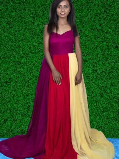 A vibrant and colorful gown with panels of magenta, red, and yellow. This simple, flowing dress is perfect for a bright and cheerful outdoor shoot.