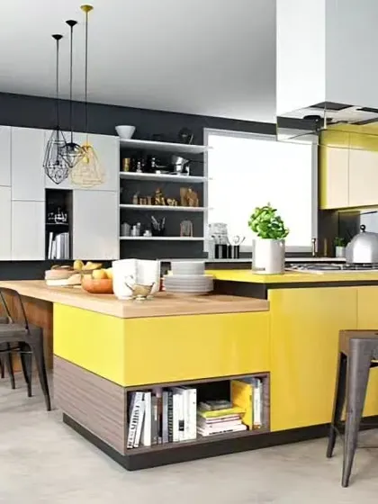 A vibrant yellow and dark grey kitchen with a large central island that serves as both a workspace and a dining area. The mix of open shelving and closed cabinets offers a balance of display and practical storage.