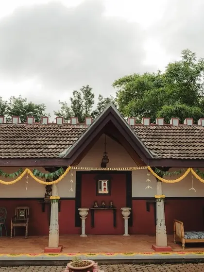 The entrance of a heritage venue decorated with marigold garlands, setting a traditional tone for the event.