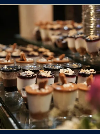 A close-up shot of our dessert shooters, with layers of cake, cream, and toppings. The shallow depth of field focuses on the intricate details of each individual dessert.