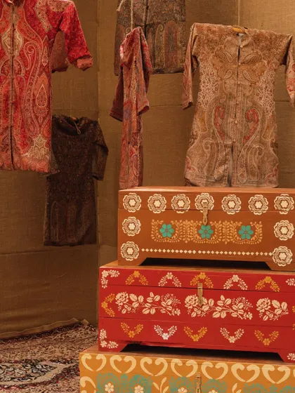 Traditional Kashmiri pherans were hung on display, alongside intricately painted wooden chests, celebrating the local culture.