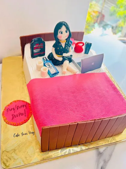A custom bed-shaped cake featuring the birthday girl with all her favorite things.