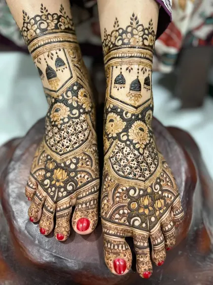 I love adding personal touches to your bridal mehendi. For this design, I incorporated delicate jhumka (earring) motifs into the foot henna, blending them with classic floral and net patterns for a unique and meaningful look.