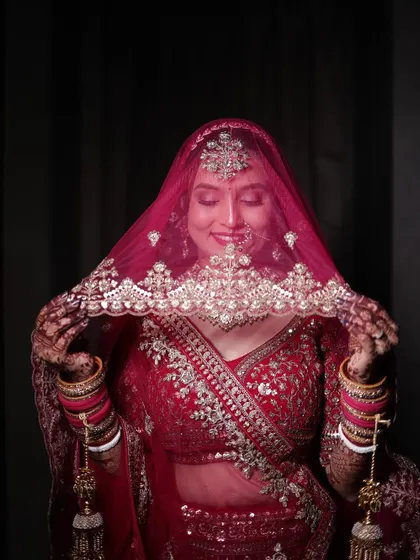A playful and shy moment with the bride peeking through her veil.
