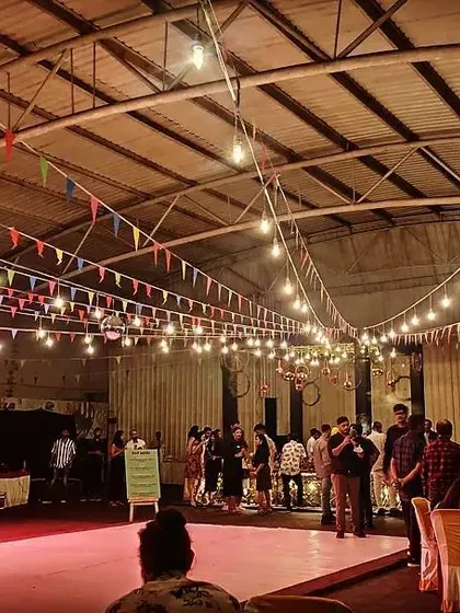 Guests mingling at a corporate party in our versatile indoor hall. The space can be configured with a mix of seating and standing areas to suit your event.