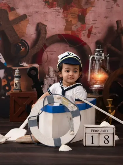 Ahoy, little sailor! This nautical-themed shoot is perfect for an adventurous little one, with props like an anchor, globe, and a mini boat.