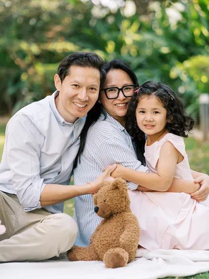 A happy family portrait on a picnic blanket. The genuine smiles and easy connection show a family comfortable with each other and with me.