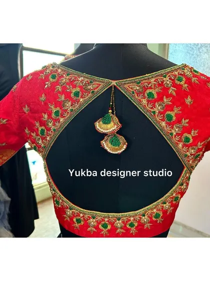 The full back view of the red cutout blouse, showing how the design creates a striking and memorable look.