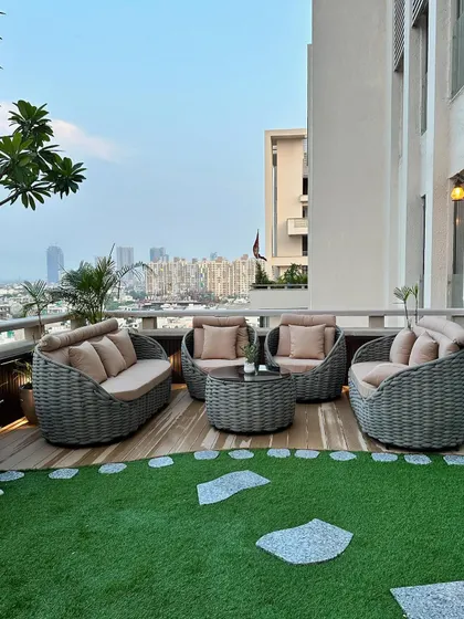 We design with your view in mind. This rooftop deck features comfortable, modern wicker furniture arranged to maximize the stunning city view, combining the best of urban living with the comfort of a private garden.