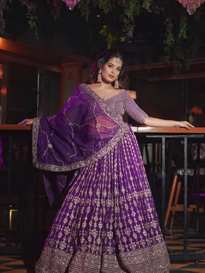 A full-length shot showing the grandeur of this reception outfit. The makeup is bold enough to balance the intricate details of the lehenga.