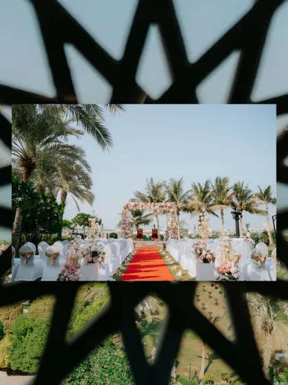 A creative shot of the wedding aisle, framed by an architectural element, adding depth and artistry to the decor photography.