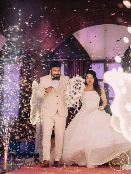 The couple's grand entrance to their reception, celebrated with a shower of confetti and cold pyro effects.