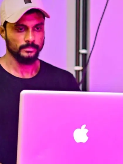 In the zone, with the pink glow of my laptop screen illuminating the booth.