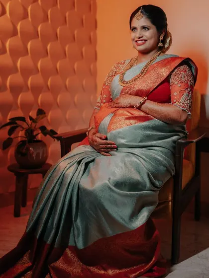 Celebrating a new beginning. This beautiful mother-to-be is glowing at her baby shower, her traditional South Indian braid and vibrant saree honouring her heritage.
