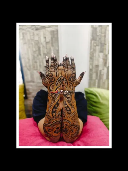 A gorgeous full-arm Dubai-style mehendi for a singer attending her brother's wedding. The flowing, intricate patterns are perfect for making a statement.