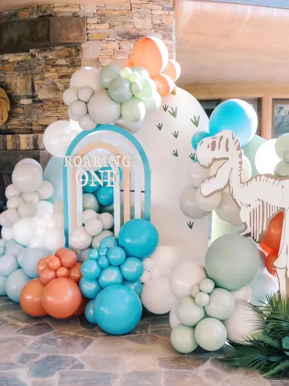 A "Roaring One" dinosaur theme in a unique pastel color palette. I love giving popular themes an artistic twist, combining cute dinosaur skeletons and footprints with soft, modern colors.