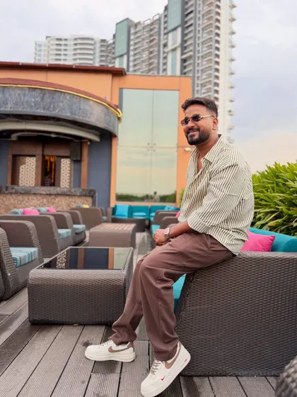 A relaxed moment on a rooftop, enjoying the city view before a gig.