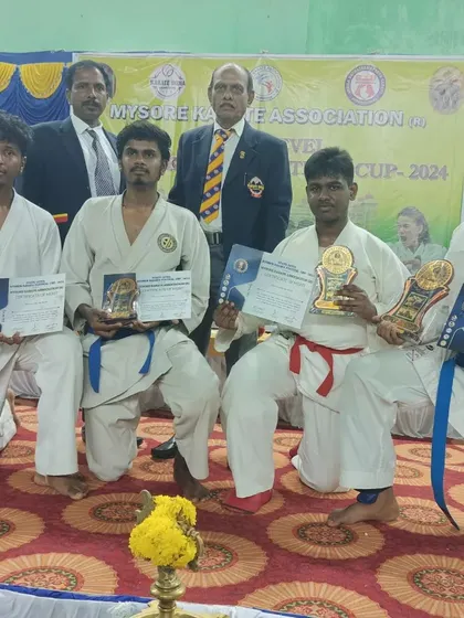 My senior students kneeling with their well-deserved awards after competing in the Mysore Dasara Karate Championship 2024.