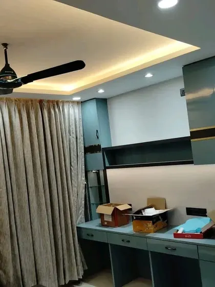 A bedroom space during the final installation phase, with boxes and tools still around.