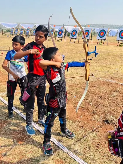 Even our youngest archers learn discipline and focus. Here, a young boy gets ready on the shooting line at a state competition, showing the confidence that comes from our structured training programs.