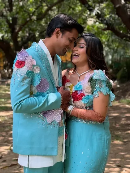 Pure happiness. This candid shot captures the joy of the couple's carnival-themed celebration. The bride's makeup is fresh and radiant, perfect for a day of fun and love.