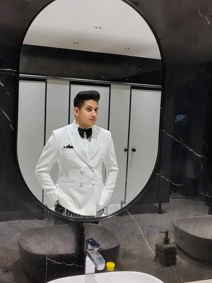 Ready for the event in our white double-breasted tuxedo. The modern silhouette and perfect fit make it an excellent choice for any formal celebration.
