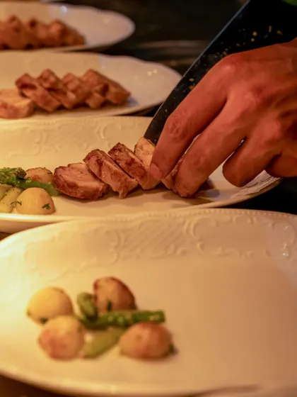 A close-up of the plating process, showing the careful arrangement of each element.