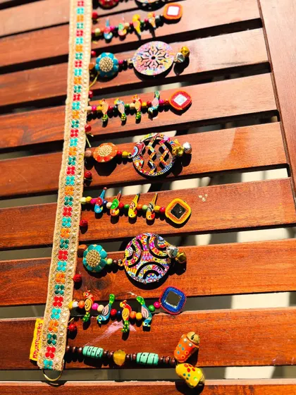 Another view of the 'Rang-Tarang' toran. The topper itself is a beautiful piece of work with its colorful embroidered flowers on a jute base.