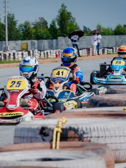 A tight pack of karts heading into a corner. Our drivers are trained to excel in these high-pressure, wheel-to-wheel racing scenarios.