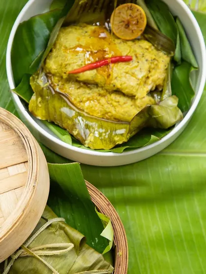 Maach Paturi, a traditional Bengali fish dish steamed in banana leaves, made with our special Aam Kasundi.