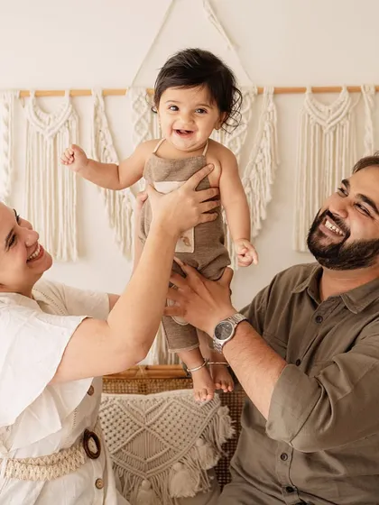 Up in the air! The pure delight on this baby's face as his parents lift him up is a perfect capture of family fun during a 6-month session.