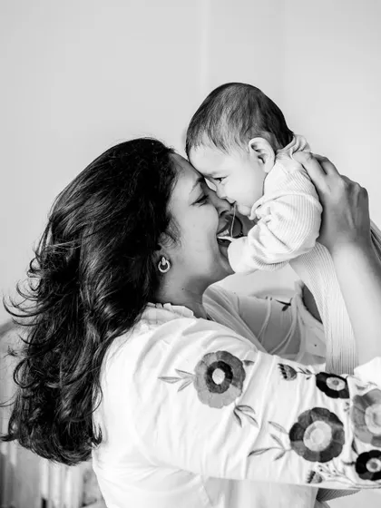 A black and white shot of a mother and her baby sharing a nose-to-nose giggle. The simplicity of monochrome puts all the focus on the pure joy and love in this interaction.