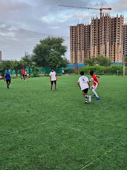A player watches intently as his teammate challenges an opponent for the ball. Action speaks louder than the coach.