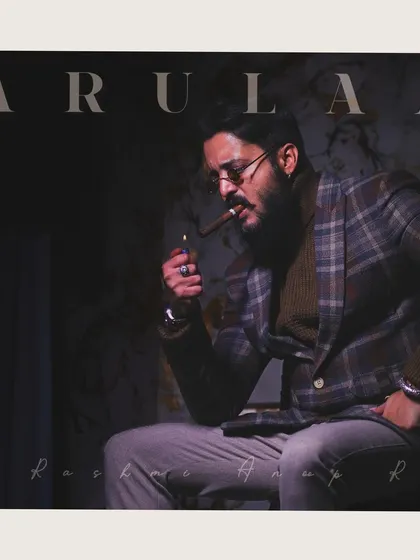 The checked blazer and turtleneck combination is a classic look. The styling with the cigar adds to the powerful, don-like character we were aiming for in this photoshoot.