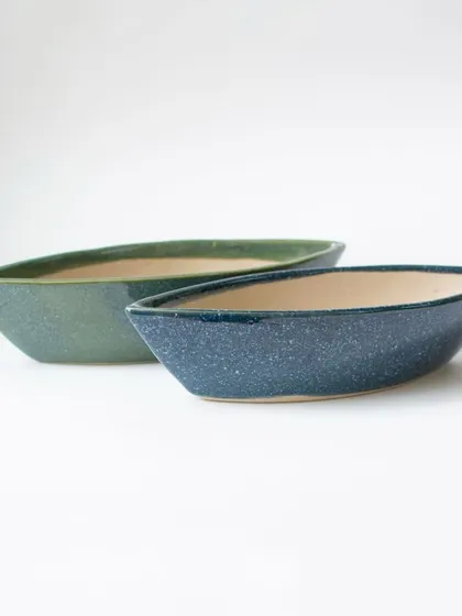 My ceramic boat planters, available in green and blue speckled finishes. Their unique, elongated shape is perfect for creating small succulent arrangements.