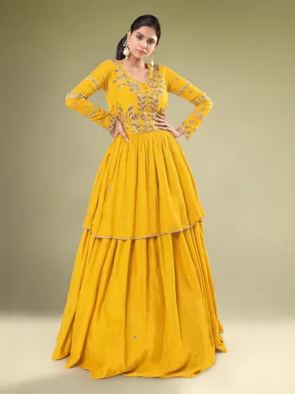 A full look at the yellow tiered Indo-western outfit. The layered skirt adds a fun and modern element to the traditional silhouette.