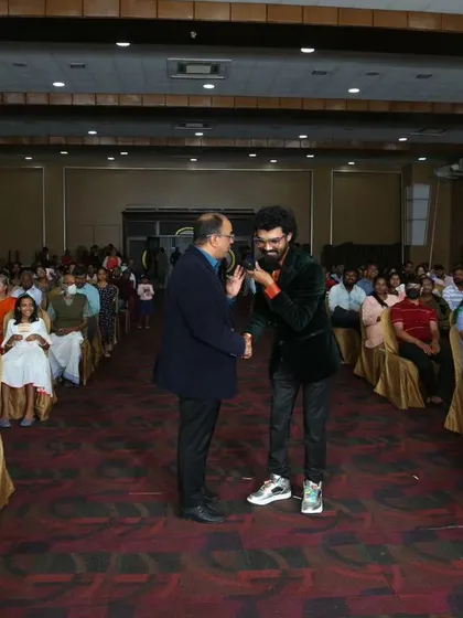 Involving a senior member of the audience in a magic trick, showing the fun is for all ages.