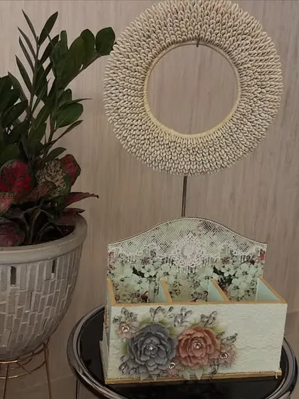 A small but elegant indoor garden arrangement. This ZZ plant, paired with a smaller red-leafed plant in a textured pot, creates a beautiful and low-maintenance decorative feature for a side table.