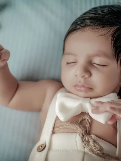 A close-up shot focusing on the baby's peaceful expression and dapper outfit in our celestial theme. The details make these portraits truly special.