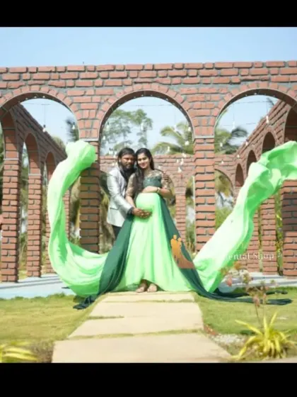 Our two-tone green flying tail gown is perfect for creating memorable couple portraits. The long train can be styled in various ways to add a unique and dramatic flair to your maternity photoshoot.