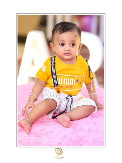 A simple and sweet studio-style portrait for a first birthday. The focus is entirely on his adorable expression and chubby baby feet.