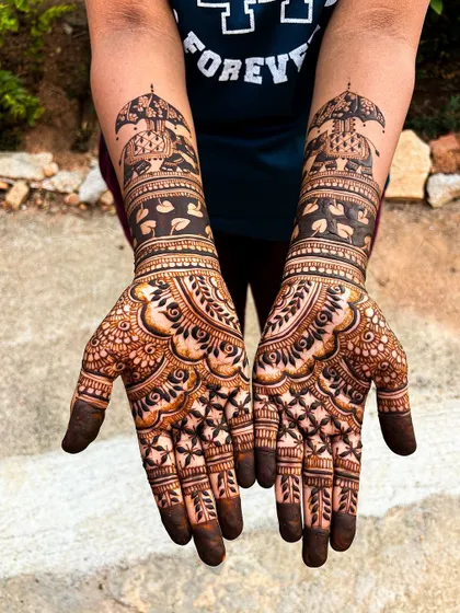 A classic bridal design with Ambari elephants and intricate patterns, freshly applied for a rich, dark stain.