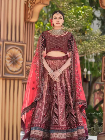 An outdoor shoot for a rental clothing brand, featuring a model in an opulent maroon and navy bridal lehenga. The images are framed to highlight the grand design of the outfit.