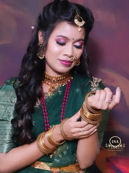 The intricate details of the jewelry and the rich fabric of the Langa Davani come together for a stunning look.