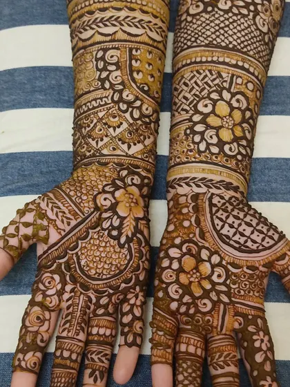 A full view of the Indian mehendi design from ID 104, showing the pattern extending up the forearm.