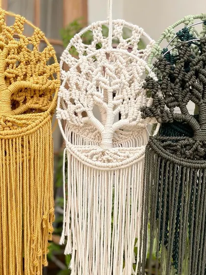 A close-up of three of my Tree of Life dream catchers in mustard, off-white, and olive green. The detail in the roots and branches is what I love to create.
