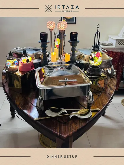A unique boat-shaped table used for a home catering event. This creative setup, adorned with lanterns and my best serveware, shows how I can work with clients to create a truly personalized experience.