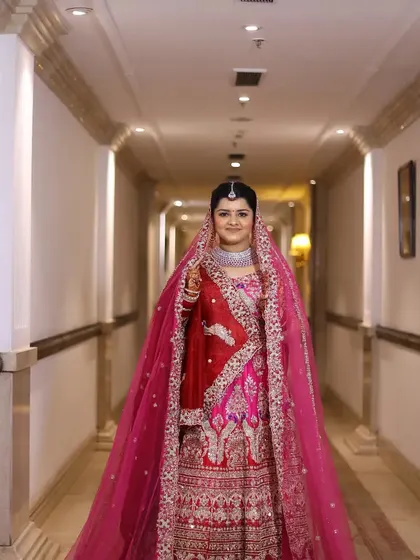 A full-length bridal portrait taken in a hotel corridor, using the leading lines of the architecture to frame her.
