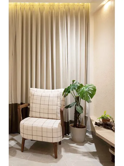 Another shot of the comfortable armchair, demonstrating how we create inviting nooks within a larger living space. The lighting is designed to be warm and relaxing.